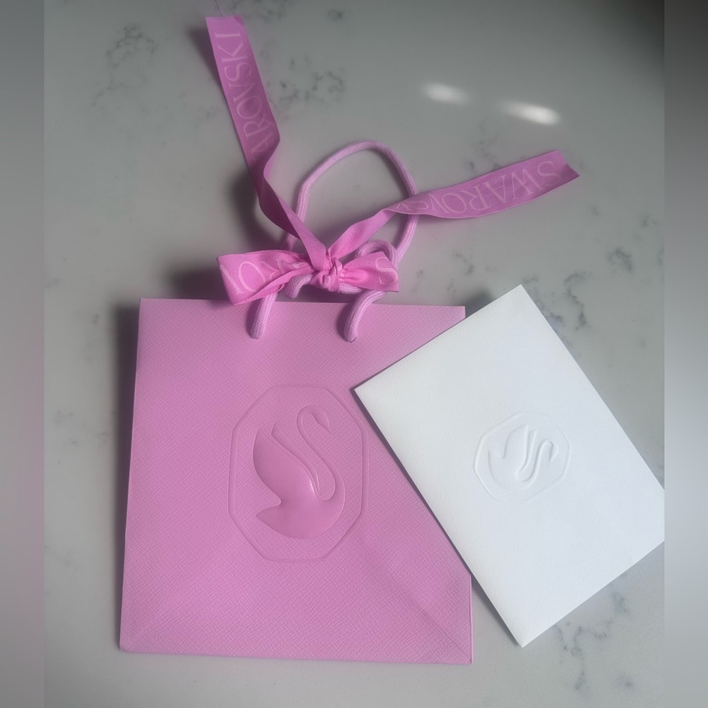 Swarovski Pink Bag with White Card and Ribbon.